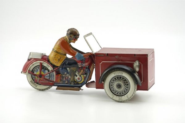 JML MOTORCYCLE DELIVERY CART: France, c. 1930's, lithographed tin, unique example features driver on cycle with large box delivery cart at front, opening lid, clockwork mechanism. 14" l.