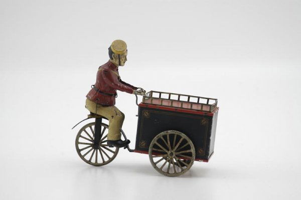 HANS EBERL THREE WHEEL DELIVERY CYCLE: Germany, very rare example from 1905, these were sometimes depicted as ice cream vendors, this figure appears attired in bellhop uniform, clockwork driven, hand painted and litho tin cart, very intrig