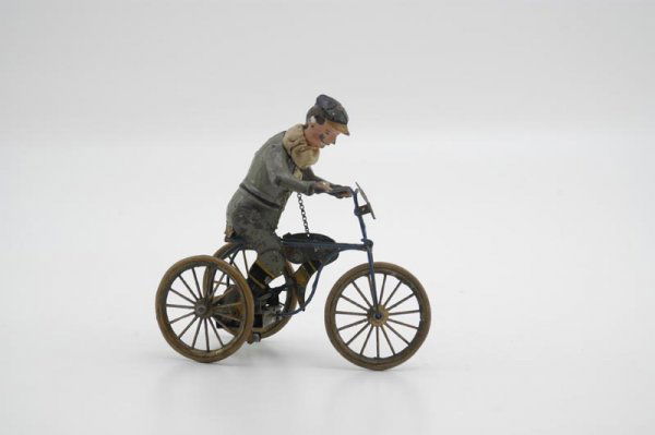1900'S TRICYCLE WITH RIDER: Attributed to Gunthermann, Germany, very intricate mechanism, allows clockwork to pull legs up by chain when activated, hand painted figure wears cloth scarf and head actually moves in motion with act
