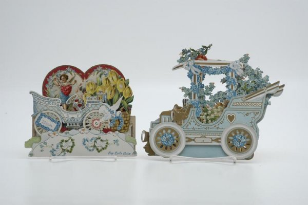 LOT OF TWO AUTOMOBILE VALENTINES: Includes a heavily embossed early convertible model loaded with floral d?cor and child driver along with fold out style card depicting child standing in auto with heart shaped back panel showing Victo