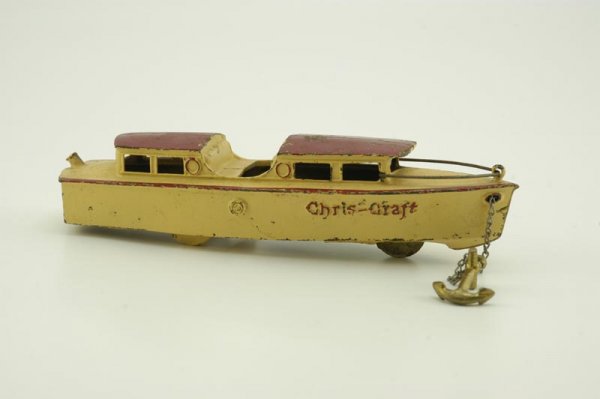 KILGORE "CHRIS-CRAFT" YACHT: Scarce and desirable cast iron example, done in cream and red colors, wire railing on bow, articulated action allows up and down motions, embossed "Chris-Craft" on sides. 11" l.