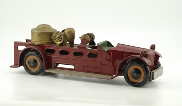 SCHEIBLE HOSE FIRE TRUCK: 1929, pressed steel, low open cab and service body painted in red, green seat, gold painted boiler, hose reel and steam dome, includes pull string, original dummy lights on fenders. 20 1/2" l.