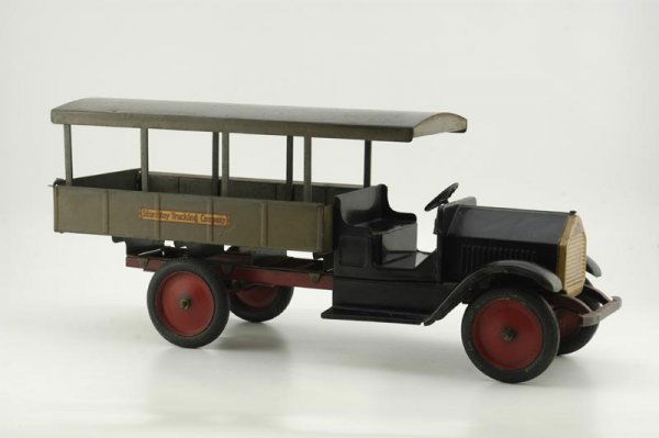STURDITOY TRUCKING COMPANY TRUCK: 1927, pressed steel, low open cab done in black, open high stake Huckster style body with roof, opening tail gate painted in grey, rubber tires, disc wheels painted in red, grille done in gold, red ch