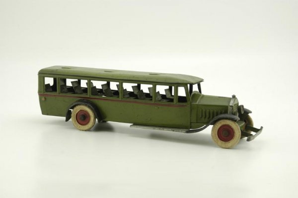 KINGSBURY PASSENGER BUS: 1925, pressed steel, painted in green overall, black fenders, interior bench seating, clockwork mechanism, white rubber tires. 16" l.