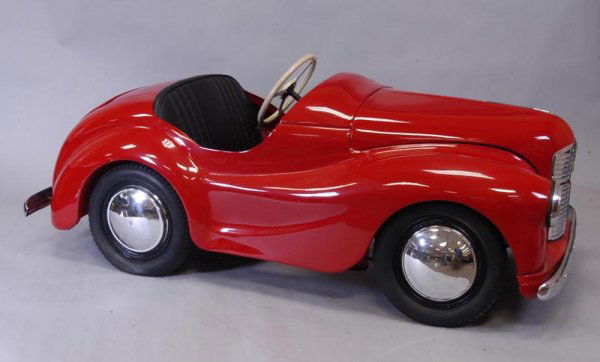 AUSTIN PEDAL CAR: England, c. 1950's, opening hood with simulated motor, opening trunk for storage, painted in red overall, quite the sports model, completely original structure, a fabulous example with replated chrome