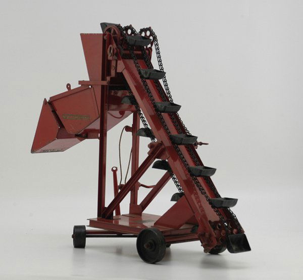 BUDDY "L" SAND SCREENER: Late 1920's, pressed steel, painted in red overall, mounted with cast wheels, features moveable front axle, folding front hopper, chain drive black sand buckets, one of Buddy L's most elaborate sand c