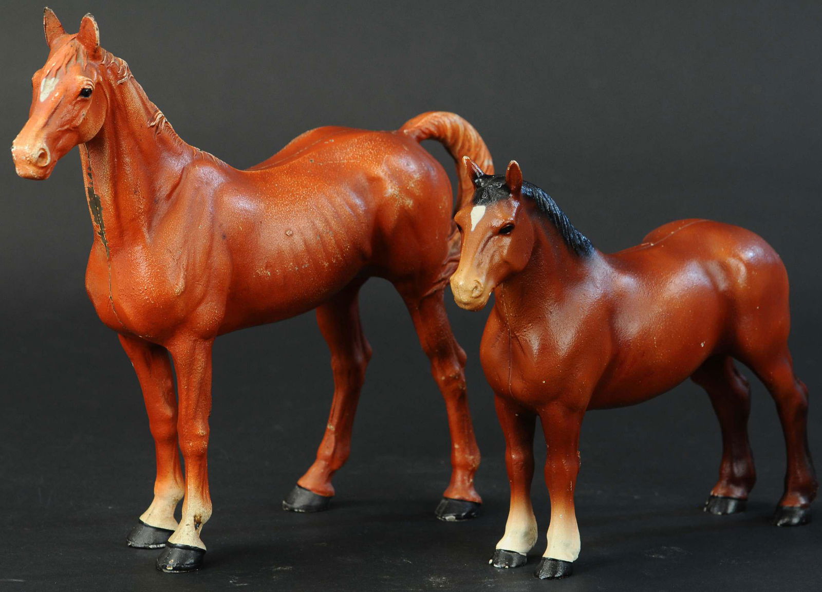 TWO HUBLEY HORSE DOORSTOPS: 31. TWO HUBLEY HORSE DOORSTOPS | Hubley, includes a large full figured horse and a Percheron work horse. | 10" - 13" l. | (Near Mint Condition) | $200 - $400