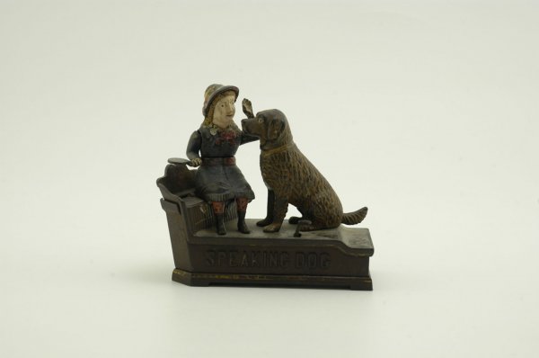 SPEAKING DOG MECHANICAL BANK (BLUE DRESS): Shepard Hardware Co., designed by Charles Shepard & Peter Adams, patented 10/20/1885. The coin is placed in a plate held by the girl. The thumb piece is pressed upon, when the girl's arm moves quickly