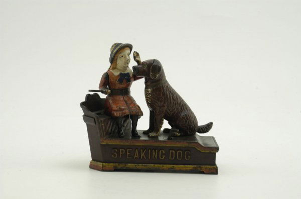 SPEAKING DOG MECHANICAL BANK: Red Dress, Stevens Hardware Co., designed by Charles Shepard & Peter Adams, patented 10/20/1885. The coin is placed in a plate held by the girl. The thumb piece is pressed upon, when the girl's arm mo