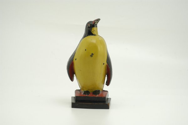 TAYLOR COOK PENGUIN DOORSTOP: Cast iron, a favorite to many collectors, this very rare variation includes a wooden base and backing shaped to penguin's form; a very colorful example. 5 1/4" w. x 9 1/2" h.
