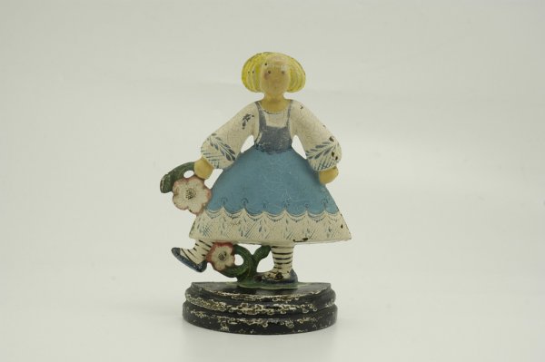 GIRL KICKING FLOWERS DOORSTOP: Whimsical casting of girl stepping over flowers, depicted in blue and white dress. 9 3/4" h. x 6 3/4" w.