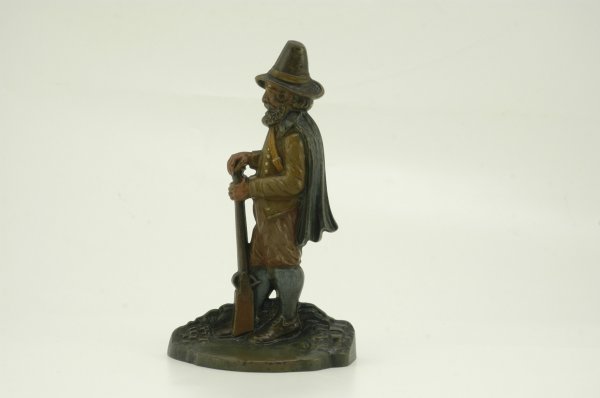 PILGRIM WITH RIFLE DOORSTOP: Bradley and Hubbard, a finely executed example w/obvious attention to molding effects. Caped pilgrim stands at ease with butt of rifle resting on foot, terrific coloring throughout. 6 1/4" x 10 1/2" h