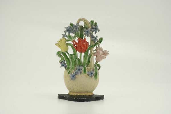 TULIPS AND HYACINTHS DOORSTOP: Hubley #471, pretty cast iron example of handled wicker basket with bright molded flowers set on black base. 6 1/4" w. x 9 1/2" h.
