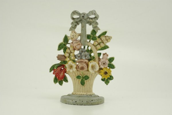 LILIES OF THE VALLEY DOORSTOP: Hubley, beautiful casting effects, features charming floral setting in white basket w/matching bow handle. 7 1/2" w. x 10 1/2" h.