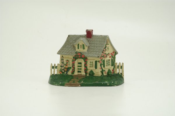 CAPE COD COTTAGE DOORSTOP: Colorful version of seaside home with small dormer at roof; green foreground and leaves give a bright appearance overall. 7 3/4" w. x 5 1/2" h.