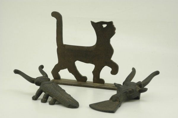 TWO BOOT JACKS AND BOOT SCRAPER: Nice grouping of cast iron novelties, includes a "1925 HOUSEHOLD PATENT COPY" silhouette cat boot scraper, an unusual steer head boot jack and an additional finely cast beetle boot jack. 10 1/2" - 9 1
