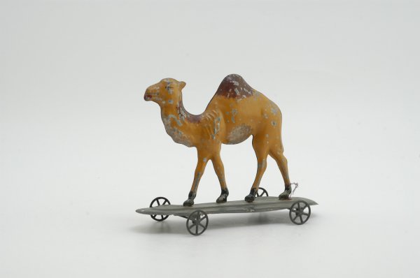 CAMEL PULL TOY: Attributed to Althof Bergmann, hand painted tin, done in brown hues, green platform base, hump painted in dark brown, cast iron spoke wheels. 8 3/4" l.