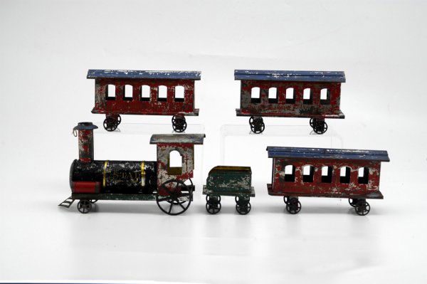 BALTIMORE & OHIO AMERICAN TIN FLOOR TRAIN: Hand painted, tin train includes locomotive and tender, together with three red and blue coaches, each read "Baltimore & Ohio," loco reads "Star," very fortunate find when complete with coaches. 30" o