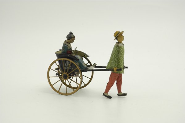 LEHMANN MASUYAMA: Germany, lithographed tin, attractive toy features Asian lady in rickshaw with floral designed parasol, pulled along by figure, clockwork mechanism. 6 3/4" l.