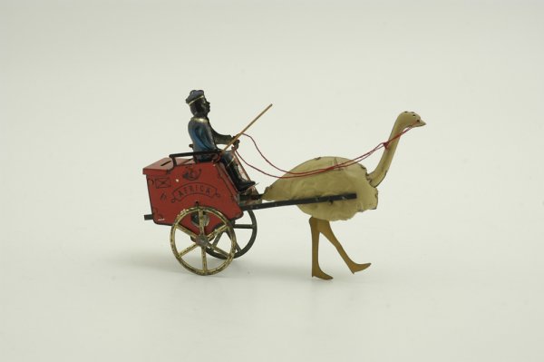 LEHMANN AFRICA OSTRICH CART: Germany, c. 1905, tinplate cart finished in red with driver in blue pulled by a single ostrich, propelled by pull string flywheel. 7 1/2" l.