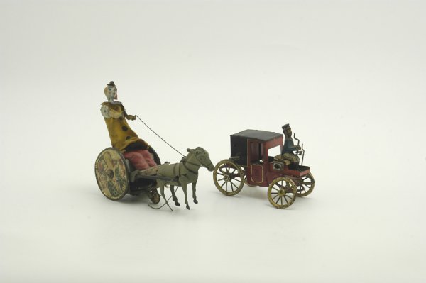 TWO LEHMANN TOYS: German, keywind tinplate, comprising a Balky Mule featuring a clown in yellow cloth suit trying to control a bucking mule; and motor car, horseless carriage with tophatted driver. 5"-7".