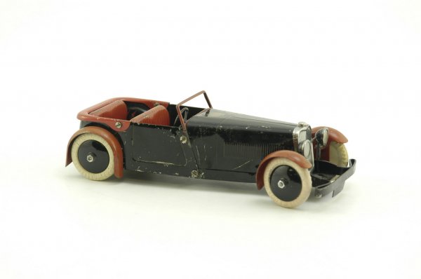 MECCANO ASTON MARTIN MARK II TOURER: Clockwork driven, done in black & red, made from assembly kit, well detailed, contains original label on hood. 8 1/2" l.