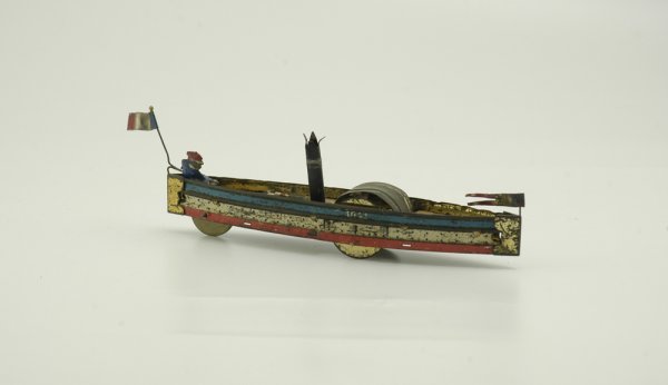 HESS RIVER BOAT: Lithographed tin, similar hull as sailboats by company, features stack on deck, this may be a fantasy creation, sold as-is, figure at stern appears added. 9 1/2" l.