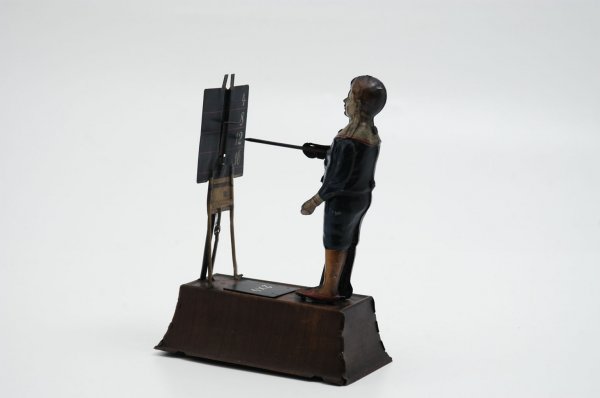 THE LITTLE CALCULATOR: Tipp & Co., Germany, c. 1925, lithographed tin, depicts school boy standing at chalkboard on easel, clockwork allows tin child to point to answer board. An overall cleaning could yield surprising cond