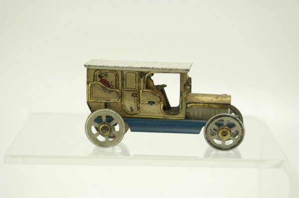 DISTLER SALOON PENNY TOY: Tin, saloon auto w/opening door, contains driver and lithographed passengers in rear, blue flooring and white spoke wheels. 3" l.