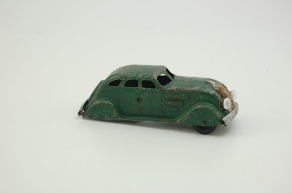 PROTOTYPE 1934 CHRYSLER AIRFLOW: Possibly by Marx, light pressed steel sedan painted green w/silver bumpers and grille, featuring integrated spare tire, electric headlights, black tires. 6 1/2" l.