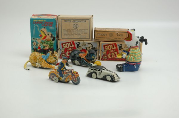 FIVE WIND-UP TOYS: Boxed items includes Candy Loving Canine, Mystic-Motorcycle, Tricky Taxi, and two Roll Over Cats, all lithographed in tin. 4" - 6"