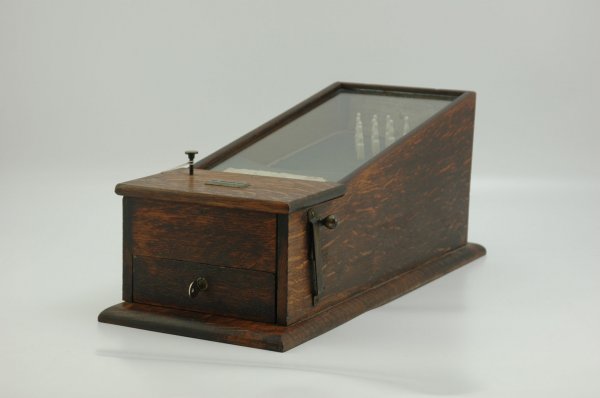 AMUSEMENT COIN-OP BOWLING GAME: Winning cigars by score, wood cabinet, glass top, interior bowling pins able to drop when ball is shot from pull down lever, fraying to felt liner. 21" l.
