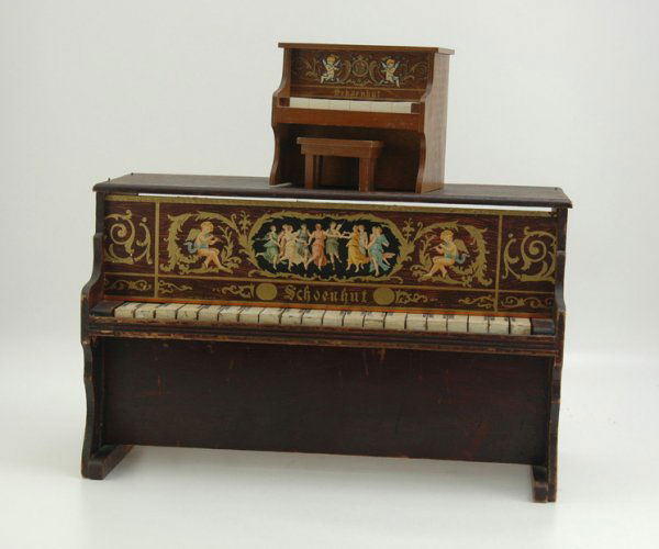 TWO SCHOENHUT PIANOS (LARGE & MINIATURE): Both done in wood, miniature model is a self playing music box piano with wind up action, large example is for child's play. 7 1/4" to 21" .