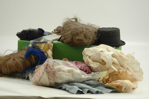 ASSORTED LOT OF DOLL WIGS, CLOTHING & SHOES: Includes old pair of shoes long impressed "17" on soles, two large wigs, one of newer human hair, one antique mohair, hats, odd assortment of dresses, mainly newer and/or homemade, also includes odd p