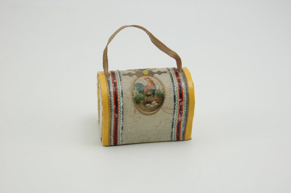 WONDERFUL CARPET BAG LUGGAGE CANDY CONTAINER: Elaborately decorated example with colorful border trim, scrap paper roosters and applied gold Dresden accent at top with centered small yellow bead; strap handle fitted through lid for ease of keepin