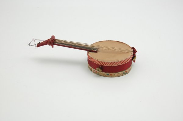 DRESDEN BANJO CANDY CONTAINER: Germany, nicely done example has decorative floral and stripes pattern along with silk material covered neck and mid section, twine strings and bells add to overall appeal. 7 1/2" l.