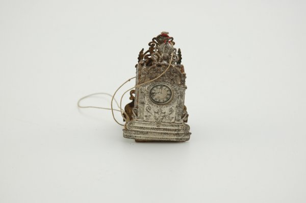 EARLY DRESDEN CARRIAGE CLOCK CANDY CONTAINER: Germany, highly embellished example painted in silver, accented with paper clock faces. 2 1/2" h.