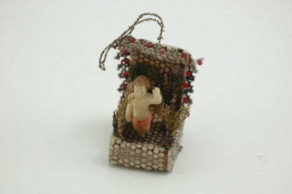 EARLY SEBNITZ ANGEL IN CANOPIED BED: Mixed medium, well crafted by hand, depicts wax angel with Dresden wings seemingly standing in air, bed trimmed with glass beads and tinsel, very unusual example. 3" h.
