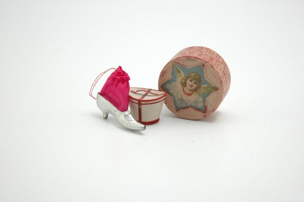 THREE DRESDEN CANDY CONTAINERS: Group consists of silver slipper marked Germany with pink bag (replaced), a drum shaped box with scrap paper decoration and red and white hat box that opens at bottom for candy storage,. 1 1/2" to 3" 