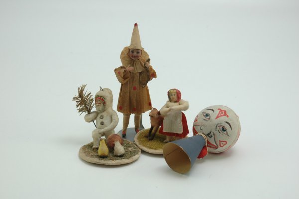 GROUP OF FOUR CHRISTMAS ITEMS: Group contains a wood and paper clown horn, a spun cotton, composition faced clown with Dresden mandolin in hand and two circular based spun cotton examples, one with kneeling Santa, the other a child
