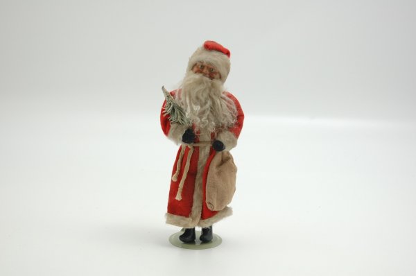 EARLY GERMAN SANTA WITH SMILING FACE: Delightful hand painted celluloid face, carries sprig in arm, composition boots painted black, wears red felt robe with white fur trim. 11" h.