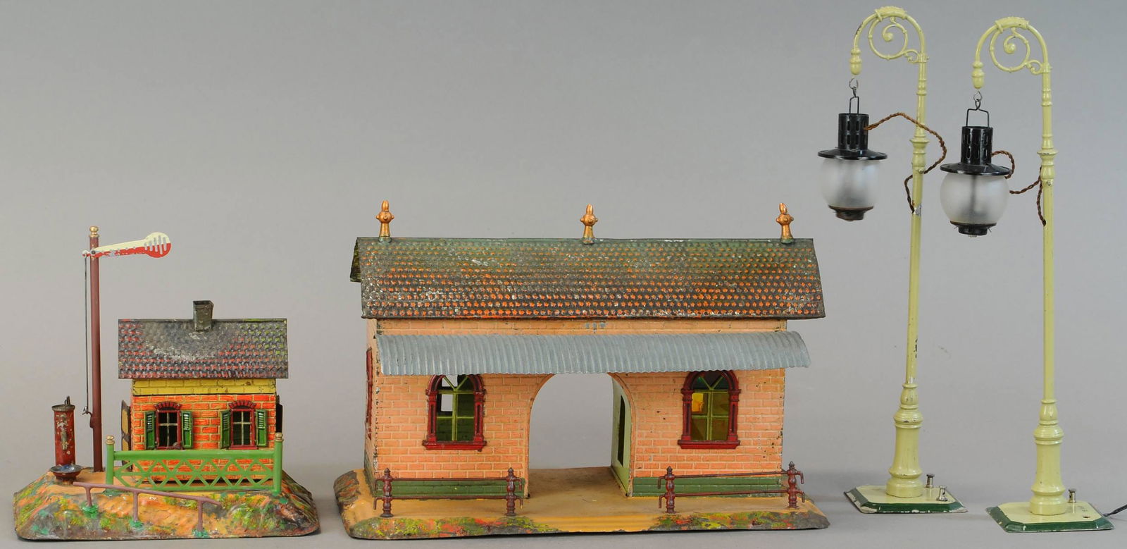 BING STATION, GUARD'S SHACK, AND LAMPS: 1005. BING STATION, GUARD'S SHACK, AND LAMPS | 14.5" h. | Guard shack has replaced roof, replaced post & seat back, over-paint to brown base on large station. | $300 - $600