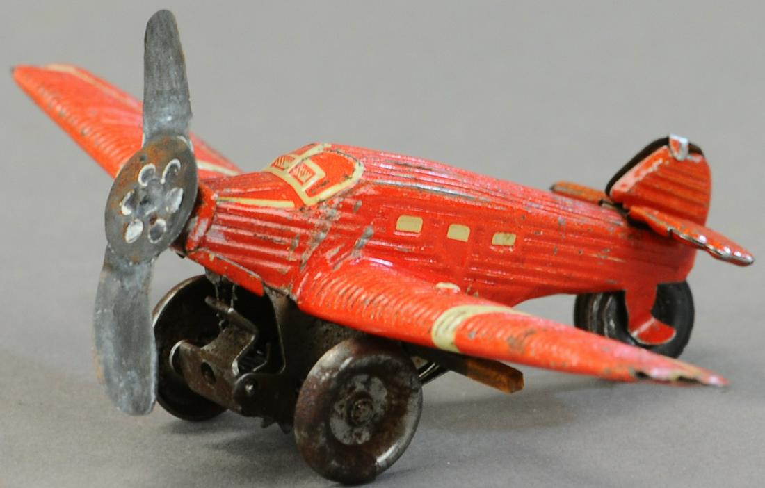 SPRING-LOADED AIRPLANE PENNY TOY (1 of 3)