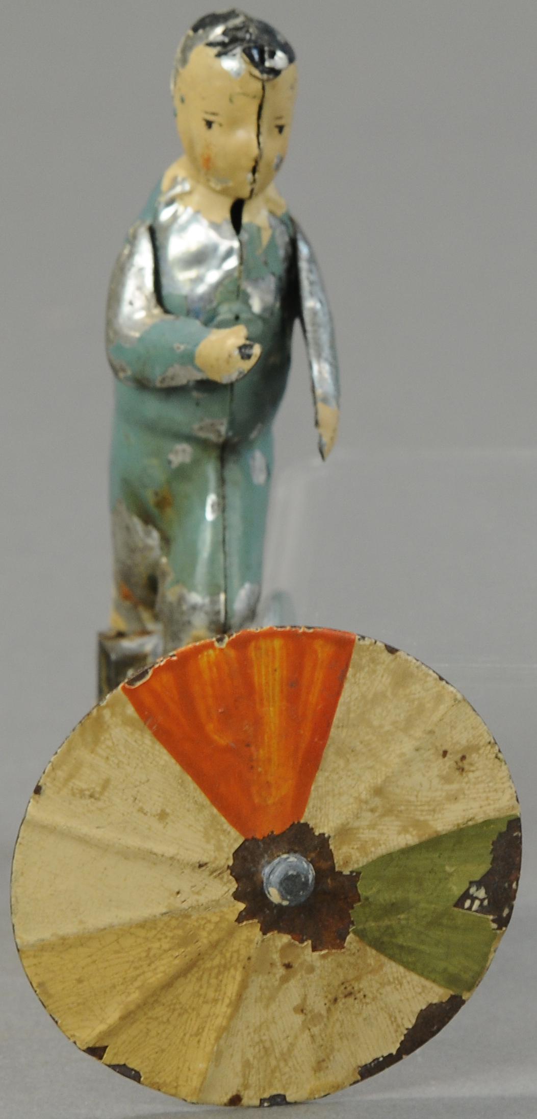 GERMAN BOY SPINNING UMBRELLA TOY: 1120. GERMAN BOY SPINNING UMBRELLA TOY | 5" h. | All Original Condition. | $250 - $500