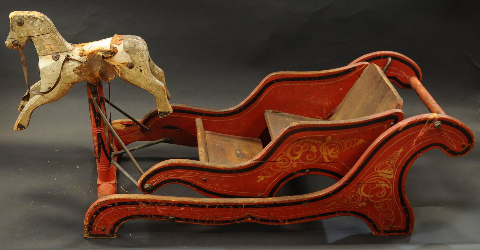 CRANDALL SLEIGH WITH BOBBING HORSE: 1184. CRANDALL SLEIGH WITH BOBBING HORSE | A fabulous Crandall bobbing horse rocker with splendid paint decoration, horse shows age appropriate wear. | 50" l. | (VG-Exc. Cond.) | $900 - $1,200