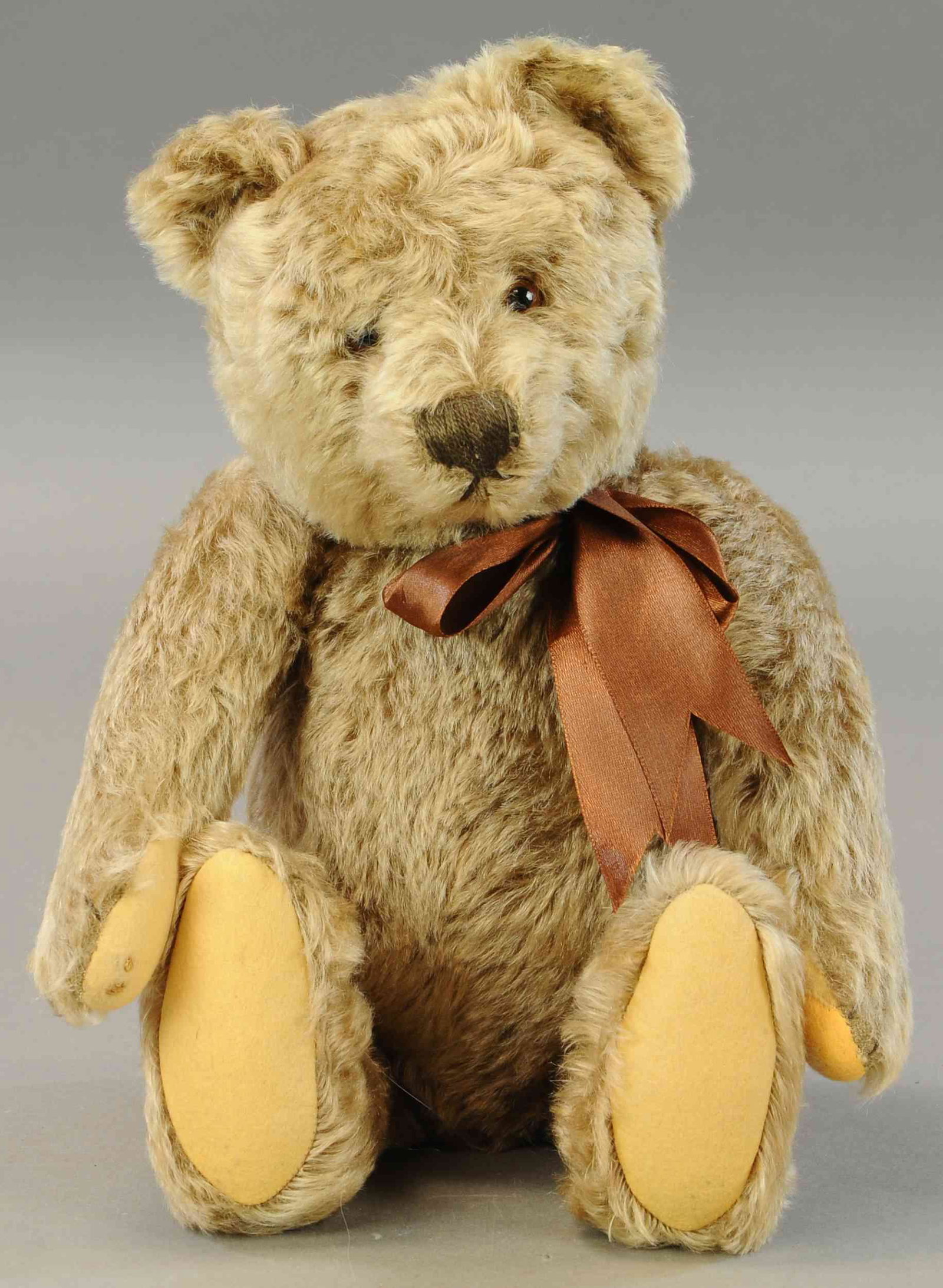1950S ERA SILVERED-BEIGE MOHAIR TEDDY: 1236. 1950S ERA SILVERED-BEIGE MOHAIR TEDDY | Although no button, remaining has all the characteristics of Steiff with brown glass eyes, brown stitched nose, mouth and claws, felt paw pads (minor repa