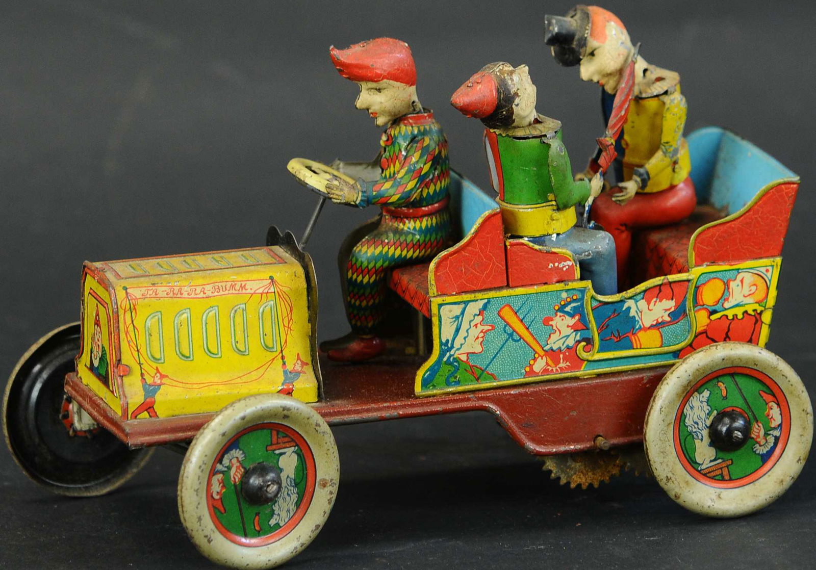 HANS EBERL TA-RA-RA-BUMM CLOWN CAR: 110. HANS EBERL TA-RA-RA-BUMM CLOWN CAR | Iconic comical car has multiple comical actions by clown figures as the car is in motion, a very popular German toy. | Provenance: Paul Cole Collection. | 7.5