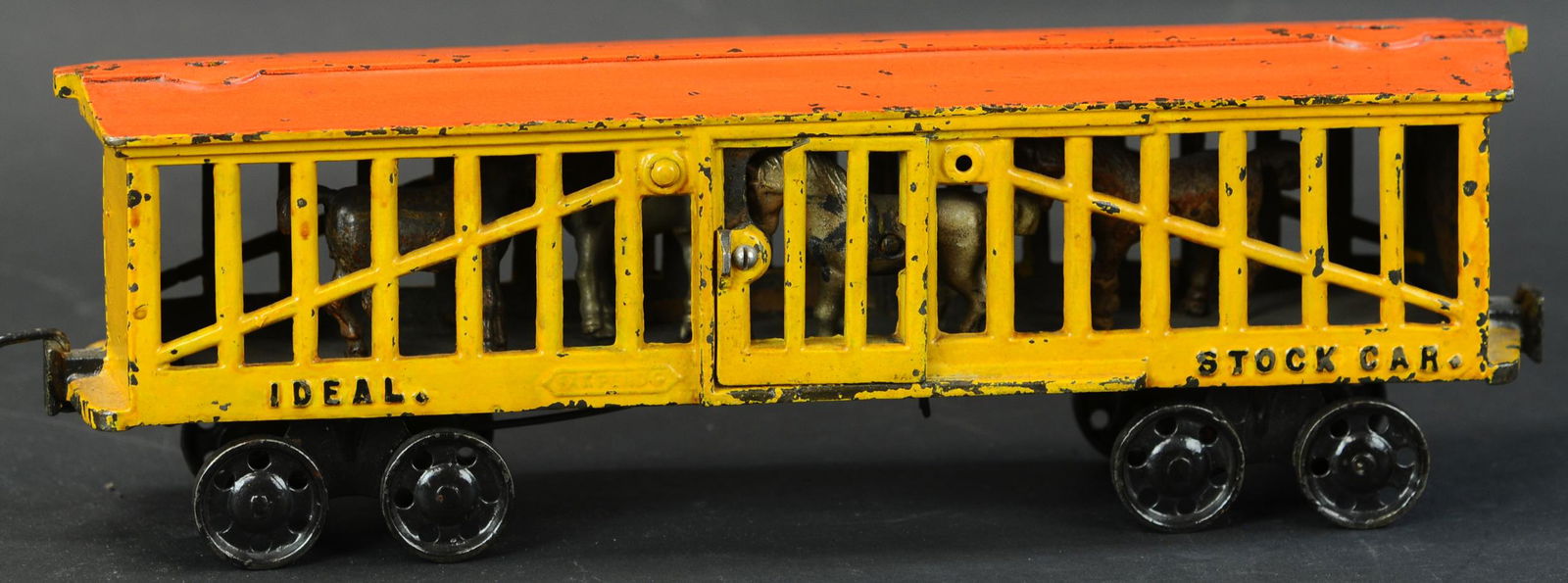 IDEAL MFG CAST IRON STOCK CAR: 356. IDEAL MFG CAST IRON STOCK CAR | Circa 1910, features sliding side doors which allow access to four horses contained within, as car rolls, floor moves back and forth simulating horses prancing. |