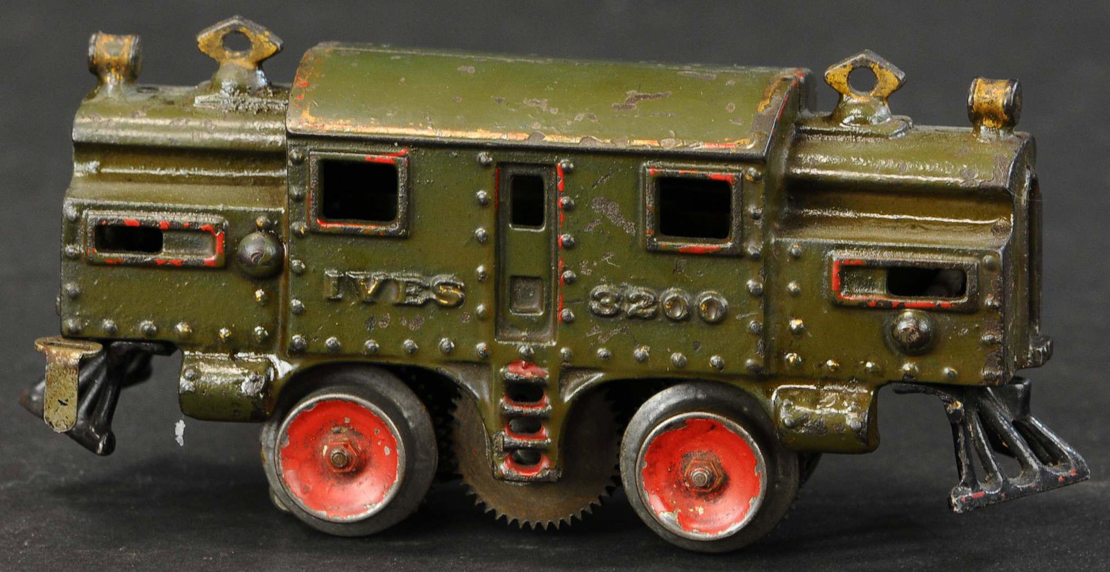 IVES OLIVE GREEN #3200: 832. IVES OLIVE GREEN #3200 | O gauge, electric, hand painted in green, 1910 version. | Provenance: Paul Cole Collection. | 6.5" l. | (Very Good Condition) | $400 - $600