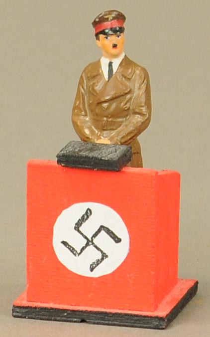 LINEOL HITLER FIGURE AT PODIUM: 443. LINEOL HITLER FIGURE AT PODIUM | 6" h. | Podium is replaced, figure in All Original Condition. | $200 - $400